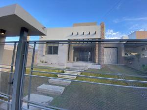a balcony with a fence in front of a building at Descanso de Liniers in Alta Gracia +5 photos