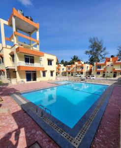a large swimming pool in front of a building at vienna Greenwood 3bd massionate mombasa pool.deck wifi in Mtwapa