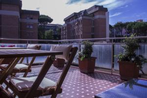 un patio con tavolo e sedie su un balcone di Domus Raffaello a Roma