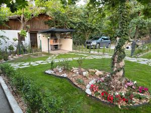 a backyard with a garden with flowers and a house at Villa Sea House in Byala