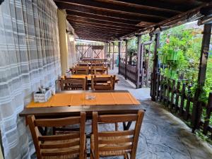 a row of tables and chairs on a patio at Guest House Starata Kushta in Lozenets +18 photos