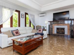 a living room with a white couch and a fireplace at Holiday Home Villa Bellevue by Interhome in Peñíscola