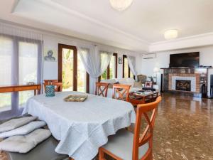 a living room with a table and a fireplace at Holiday Home Villa Bellevue by Interhome in Peñíscola