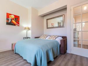 a bedroom with a bed with a blue blanket at Apartment Marines 2 by Interhome in Soorts-Hossegor
