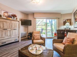a living room with a couch and chairs and a tv at Apartment Marines 2 by Interhome in Soorts-Hossegor +21 photos