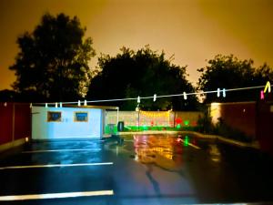 a parking lot with a clothes line with christmas lights at The Northdale Hotel Ltd in Skegness