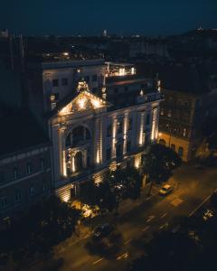 a building lit up at night with lights at Mystery Hotel Budapest in Budapest