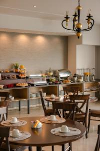 a restaurant with tables and chairs and a buffet at Niki Beach Hotel in Kamariotissa