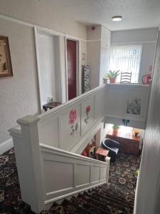 a stairway with a white staircase with flowers on it at The Northdale Hotel Ltd in Skegness