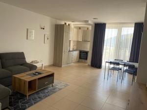 a living room with a couch and a table at Apartments Uki in Herceg-Novi