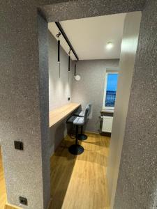a home office with a desk and a chair at Aleksandra Apartment in Ventspils +25 photos