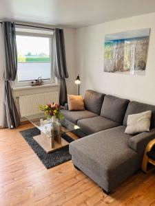 a living room with a couch and a table at Ferienwohnung Nr 4 in Hinrichsdorf