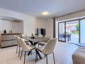 a kitchen and dining room with a table and chairs at Holiday Home Villa Marija by Interhome in Marčana