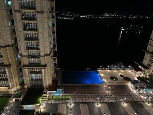 a view of a pool in the middle of two buildings at AR Homestay Riverine 2 King in Kuching +5 photos