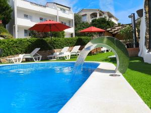 a pool with a water fountain in front of a house at Villa Marin in Pag
