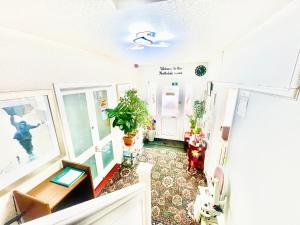 a living room with a table and plants in it at The Northdale Hotel Ltd in Skegness