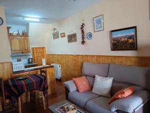 a living room with a couch and a kitchen at Casa Margarita in Bubión