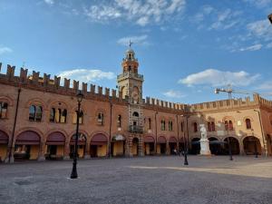 a large building with a clock tower on top of it at Appartamento Le Palmine in Cento