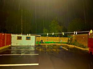 a rain soaked parking lot with a fence and a building at The Northdale Hotel Ltd in Skegness