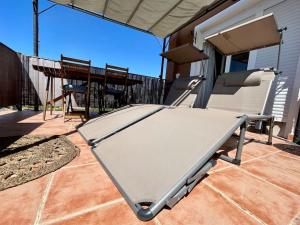 a empty bench on a patio with a table and chairs at Attic La Mirada - Bonalba Golf in Mutxamel