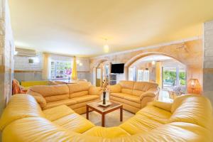 a large living room with couches and a table at Paco's Resort Luxury Villa 32 in Oziás