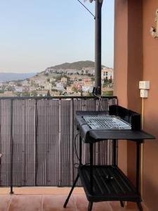 a black table with a keyboard on a balcony at Attic La Mirada - Bonalba Golf in Mutxamel