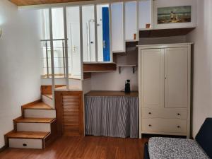 a small room with a staircase and a cabinet at Luci del Mari in Ponza