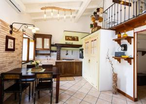a kitchen with a table and a refrigerator at Luminosa Mansarda nel Cuore di Intra in Intra