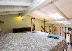 a bedroom with a large bed in a room at Luminosa Mansarda nel Cuore di Intra in Intra