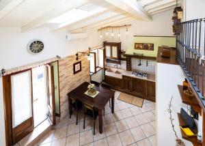 a kitchen and dining room with a table at Luminosa Mansarda nel Cuore di Intra in Intra +17 photos