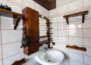 a bathroom with a sink and a mirror at Luminosa Mansarda nel Cuore di Intra in Intra