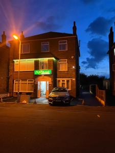 a car parked in front of a building at night at The Northdale Hotel Ltd in Skegness