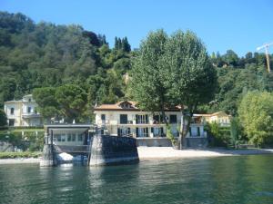 a house on the shore of a body of water at Scarlet Flower - Lago Maggiore in Meina