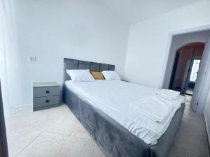 a bedroom with a large bed and a night stand at Villa Mare Blu in Sozopol +16 photos