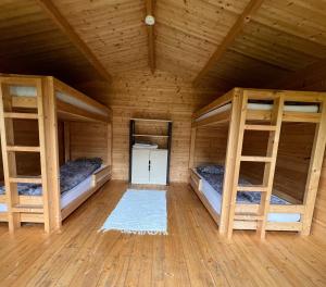a room with two bunk beds in a cabin at Tammeoja puhkemaja in Sõmeru