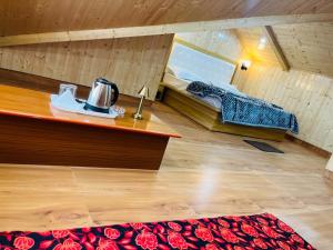 a room with a bed and a table in a room at The Massif Stay in Manāli