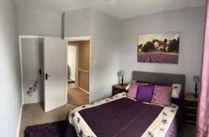 a bedroom with a bed and a painting on the wall at Four Bedroom High Spec Victorian Townhouse in Clitheroe