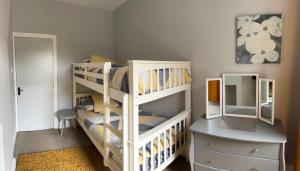 a bedroom with two bunk beds and a dresser at Four Bedroom High Spec Victorian Townhouse in Clitheroe +11 photos