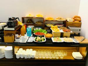 a buffet with many plates of food on a table at Liberty 2 Hotel in Ho Chi Minh City