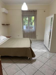 a bedroom with a large bed and a window at In famiglia apartment and rooms for Pompei, Amalfi, Sorrento and Salerno in Sant'Egidio del Monte Albino
