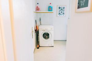 a washer and dryer in a kitchen with a door at City Apartment Singen in Singen