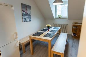 a small kitchen with a table and a refrigerator at City Apartment Singen in Singen