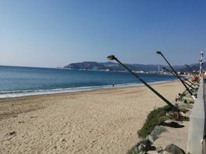 a sandy beach with two street lights on it at Casa Lella - VADOALMARE Immobiliare in Savona