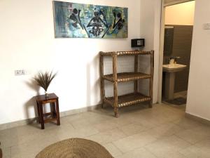 a bathroom with a sink and a toilet and a shelf at Reyna Resort By Cezere The Palm in Paje