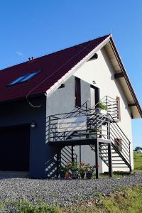 a building with a staircase and a sign on it at Dom Gościnny Przy Szlaku Jeleni in Ustroń