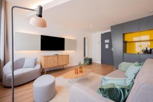 a living room with a couch and a tv at Limehome Amsterdam Gatwickstraat in Amsterdam