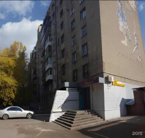 a building with a car parked in front of it at City Center - Nurken Abdirova 32 in Karagandy