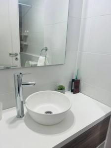 a bathroom with a white sink and a mirror at Hermoso 1amb Lindo SuperCompleto in Buenos Aires +14 photos