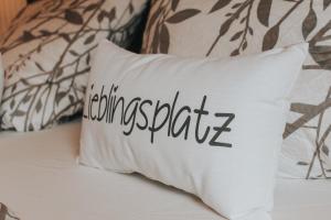 a white pillow with the word impossible on it on a bed at Ferienwohnung Nr 6 in Hinrichsdorf