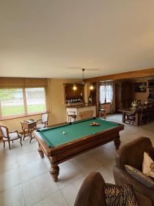a living room with a pool table in it at La Villa Boutrois in Isigny-sur-Mer